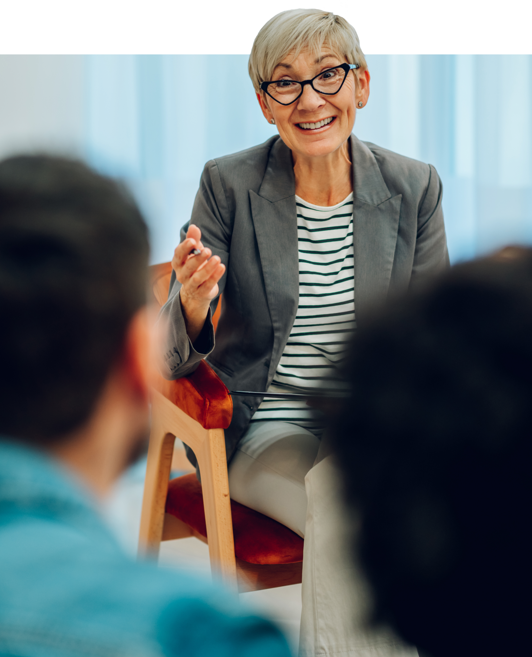 A woman psychiatrist talking with her patients.